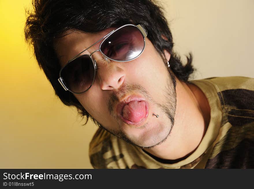 Portrait of young trendy man making funny faces