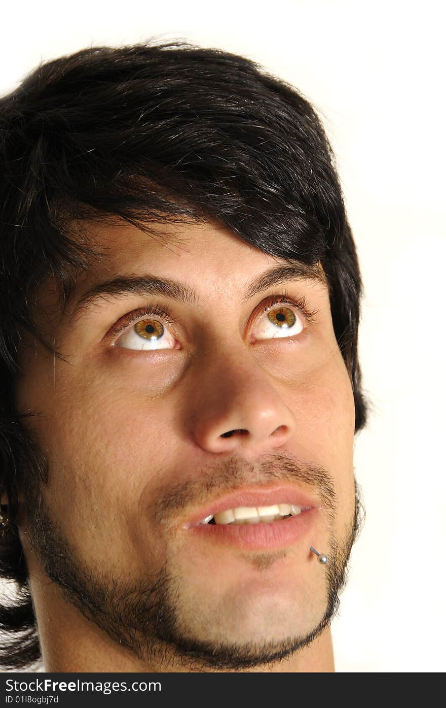 Portrait of a young hispanic man looking up - isolated over white background