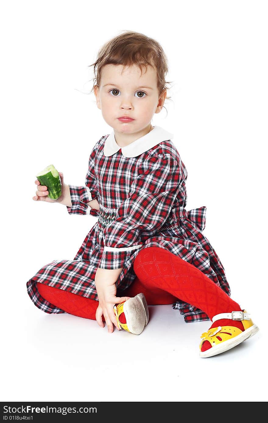 Little girl in checkered dress on white background