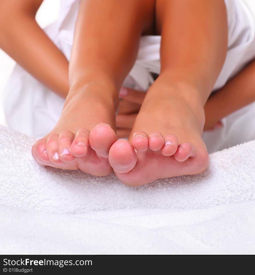 Feet and SPA Well-groomed fingers of female feet on a white towel