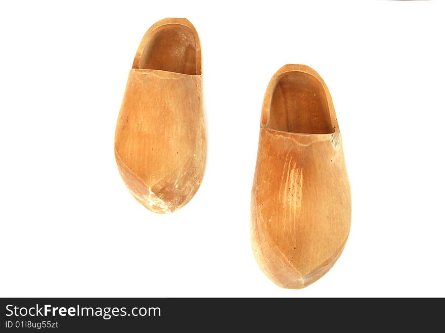 A pair of ancient wooden shoes on white. A pair of ancient wooden shoes on white