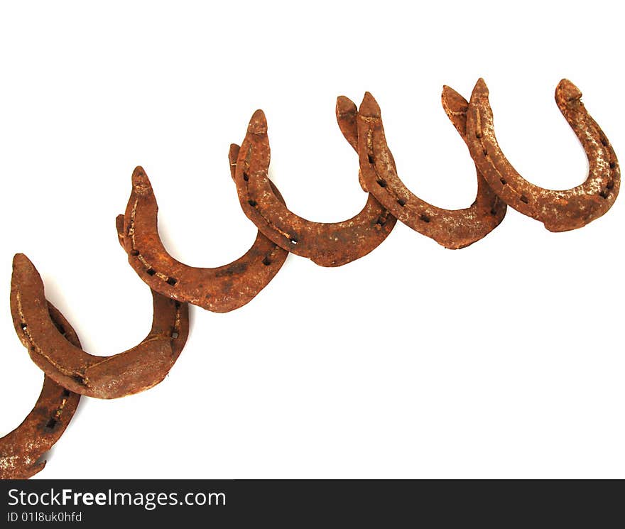 Background of old rusty horseshoes on white