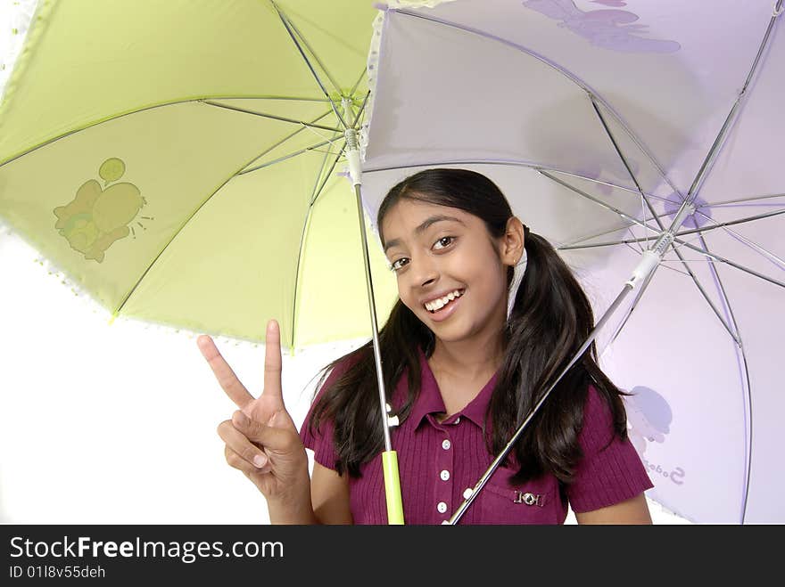 Cute girl showing two finger under two umbrella. Cute girl showing two finger under two umbrella