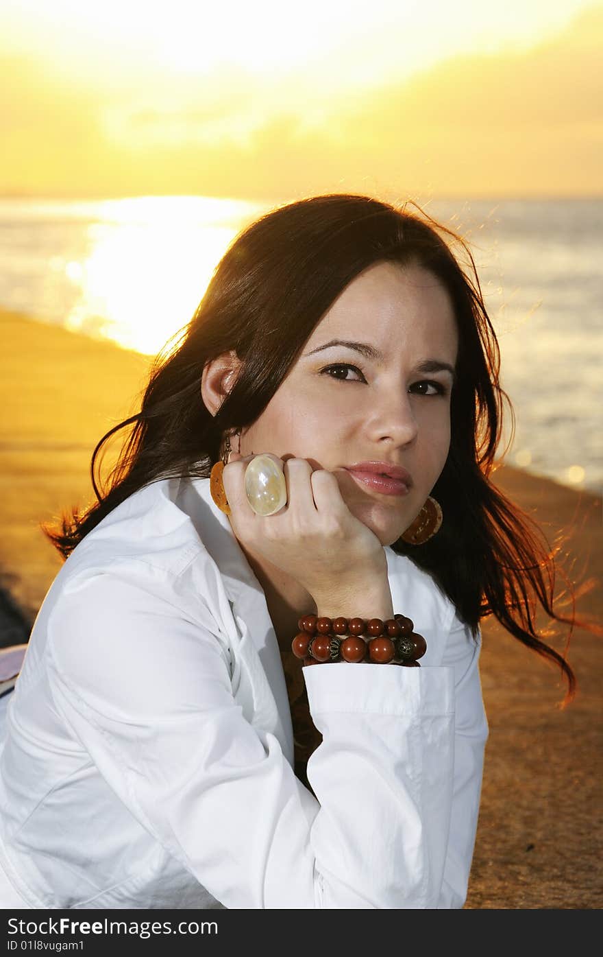 Portrait of young beautiful woman posing outdoors at sunset. Portrait of young beautiful woman posing outdoors at sunset