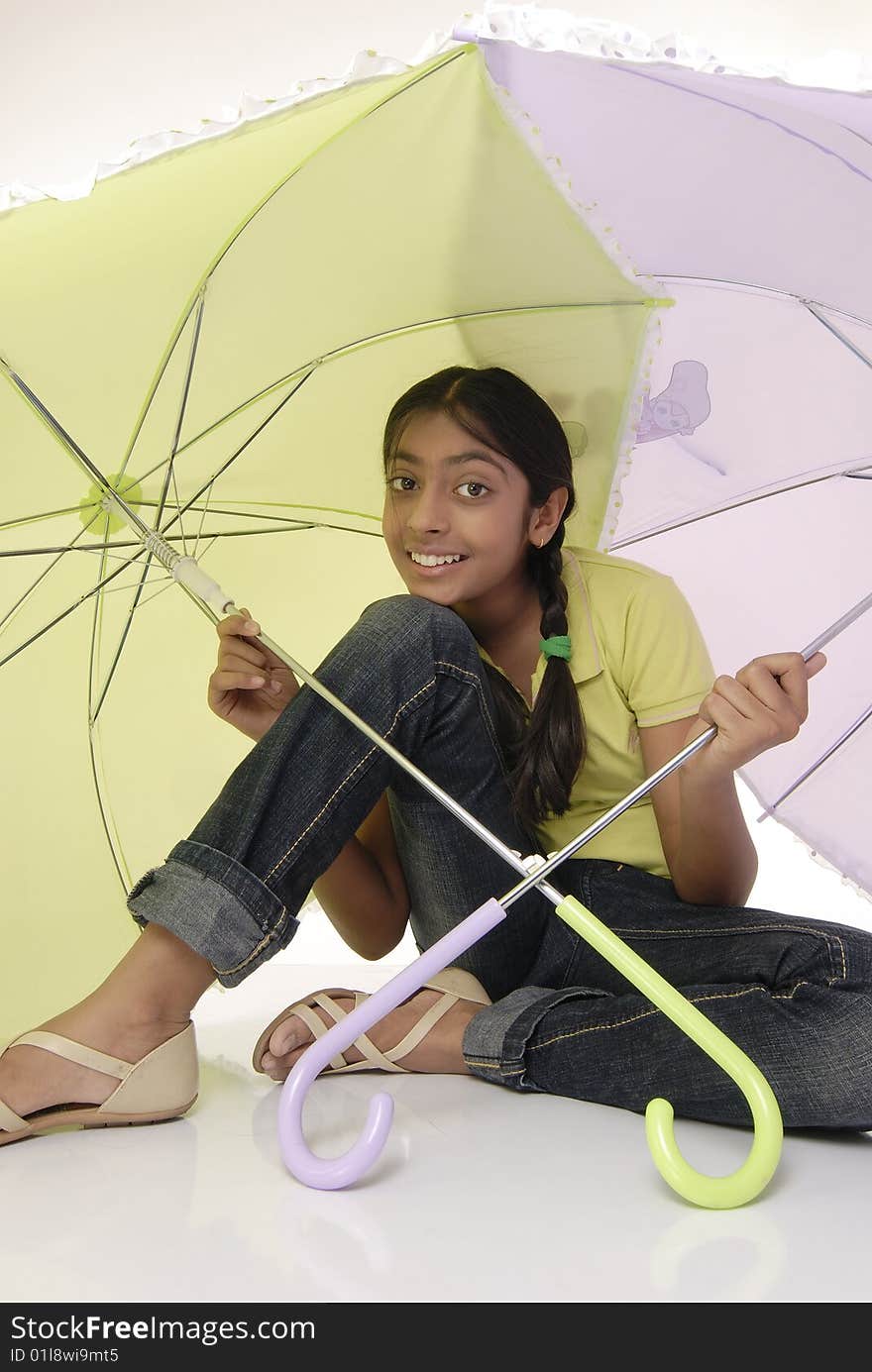 Girl sitting with two umbrella