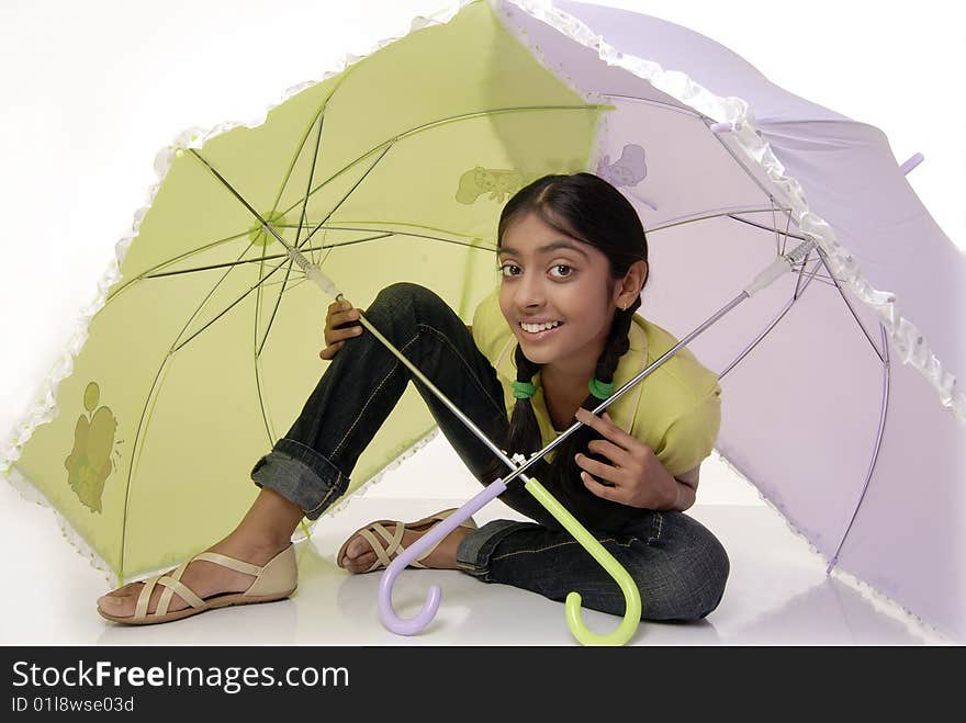 Girl sitting with two umbrella