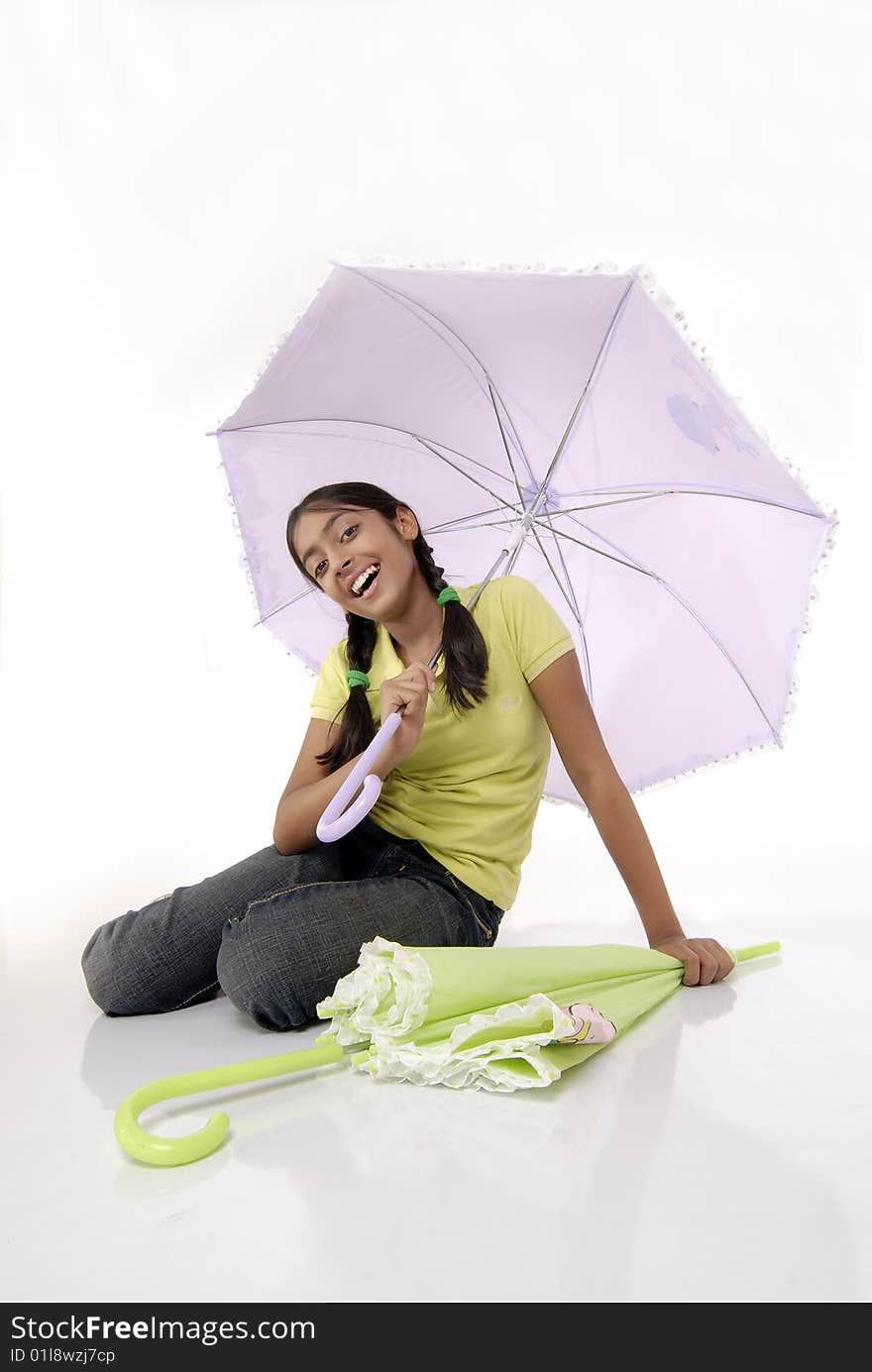 Girl sitting in umbrella