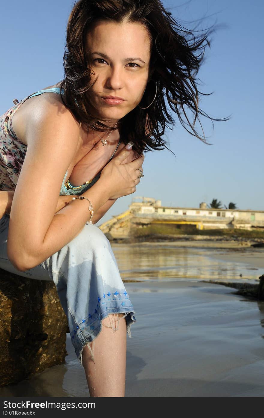 Portrait of young woman enjoying the summer breeze on the beach. Portrait of young woman enjoying the summer breeze on the beach