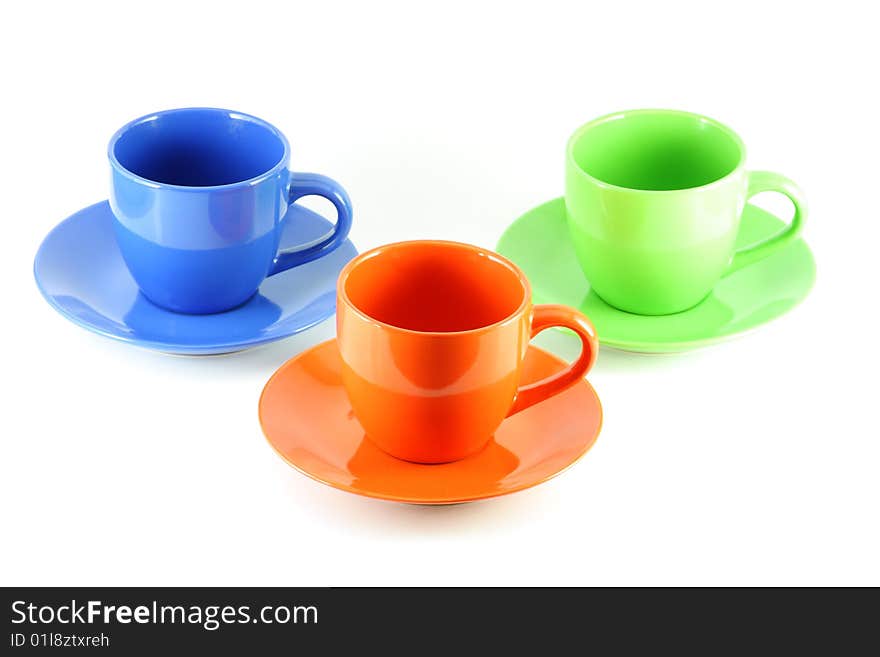 Three colored cups, isolated over white board. Three colored cups, isolated over white board