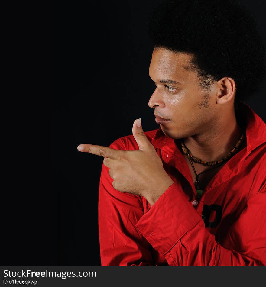 Portrait of young african man pointing finger - isolated on black