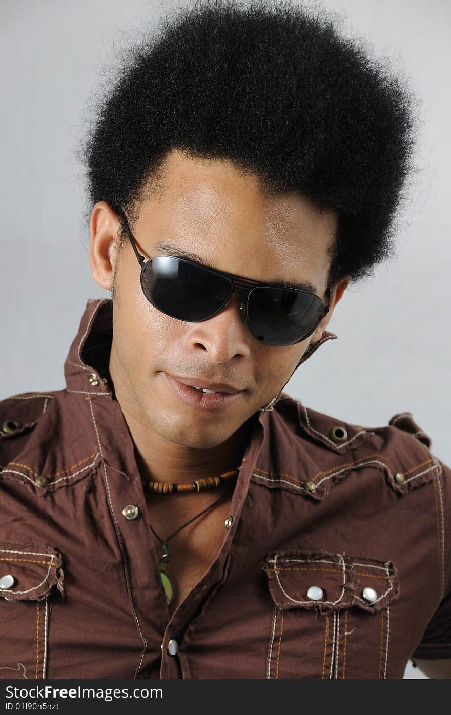 Portrait of young handsome african male model posing with sunglasses