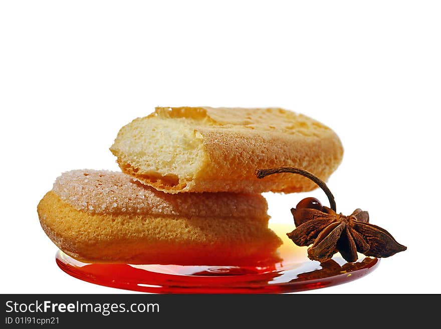 Biscuit cookies and anise spice on red plate,  white isolated macro. Biscuit cookies and anise spice on red plate,  white isolated macro