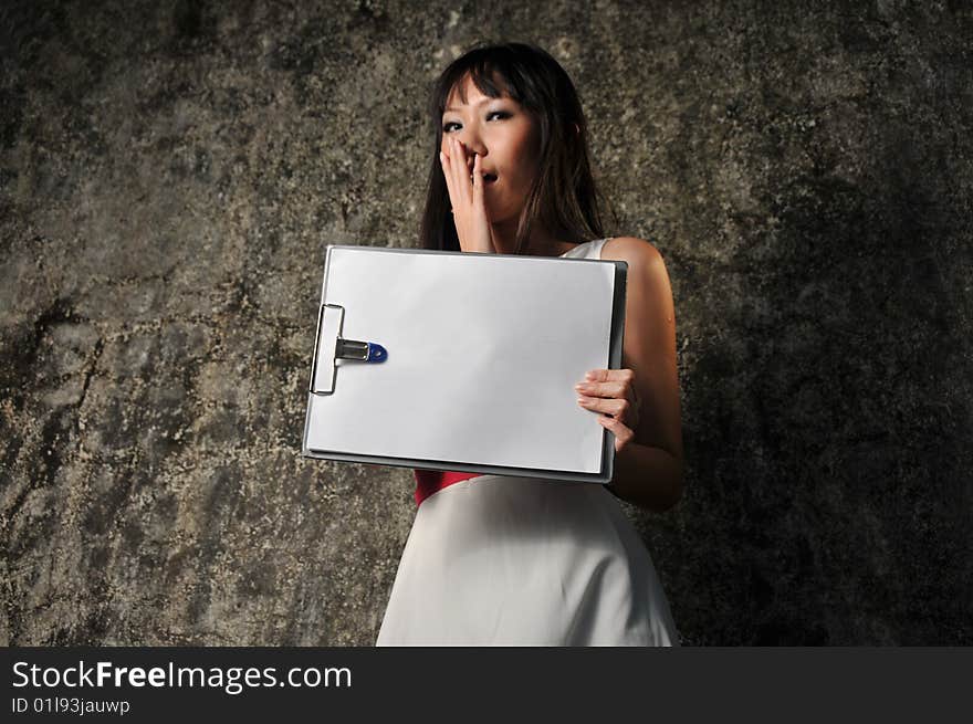 Beautiful Asian woman showing paper on clipboard and facial expression.