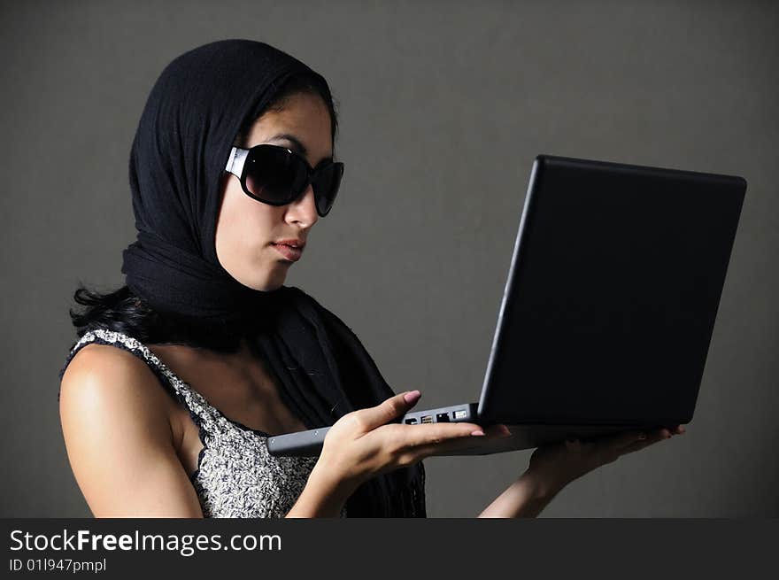 Portrait of classy woman with sunglasses holding laptop. Portrait of classy woman with sunglasses holding laptop