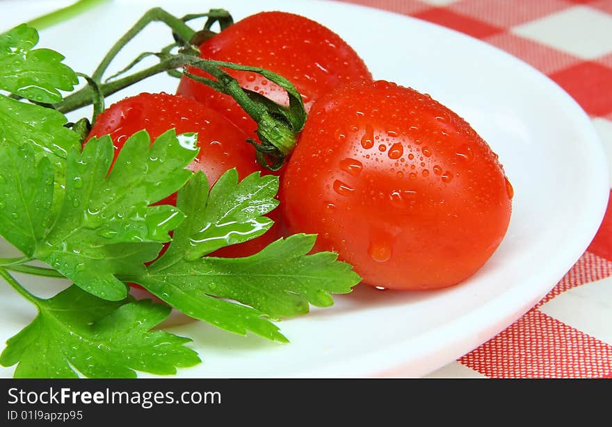 Tomato and parsley ready to eat in the plate. Tomato and parsley ready to eat in the plate