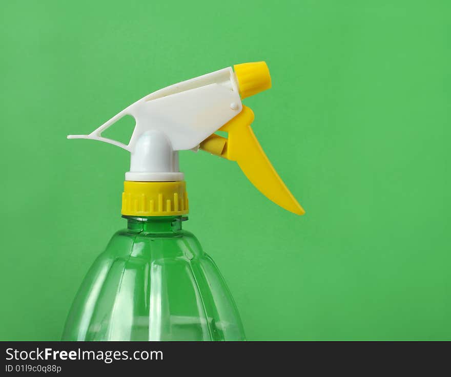 Watering can in the green background. Watering can in the green background