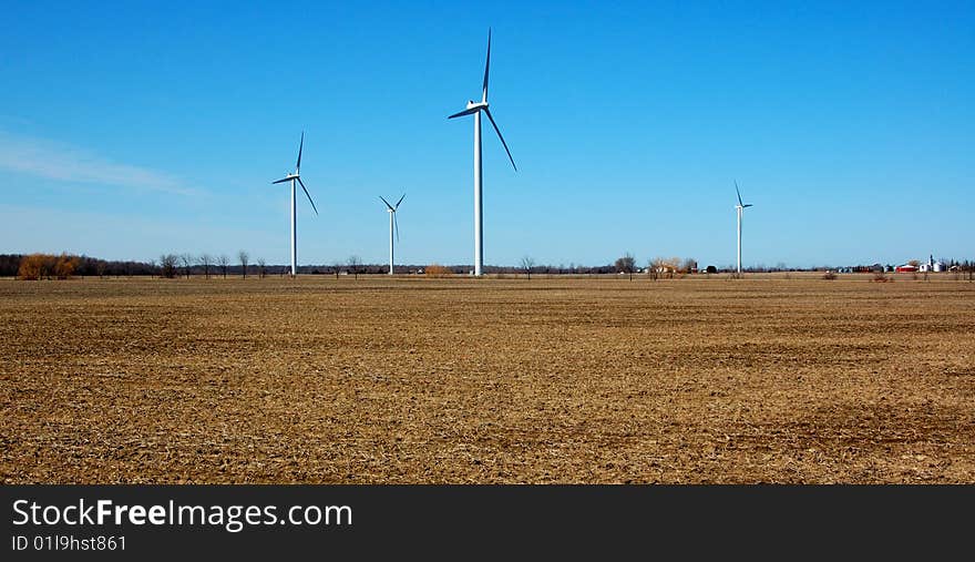 An image of a farm of wind turbines. An image of a farm of wind turbines.