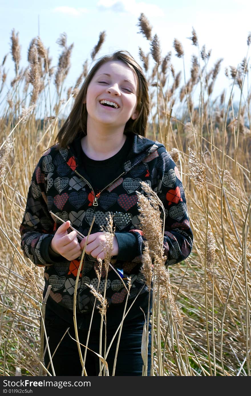 Young girl laughing in field