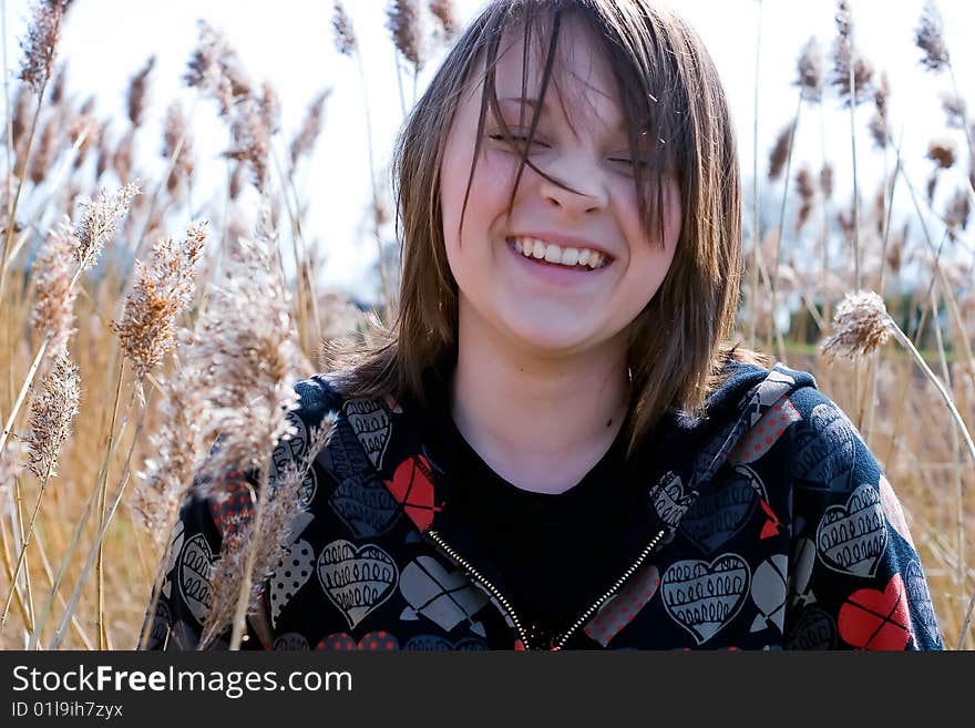 Young girl laughing in field