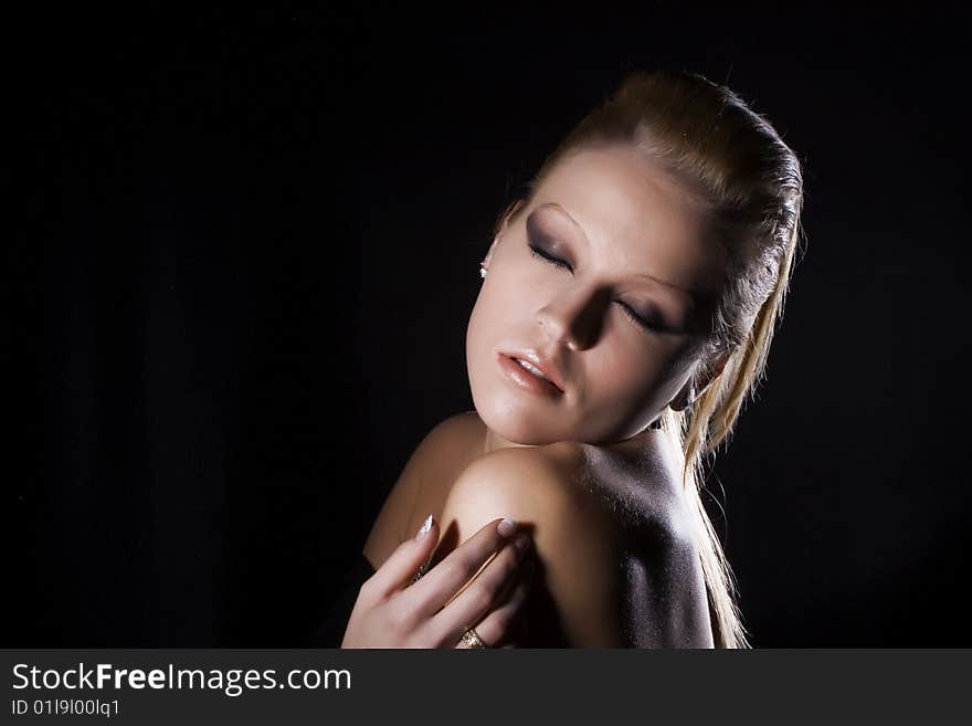 Closeup of Beautiful blond girl on a black background. Closeup of Beautiful blond girl on a black background