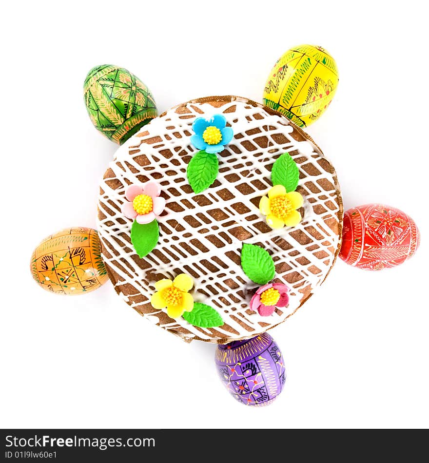 Top view of easter eggs and cake isolated on white