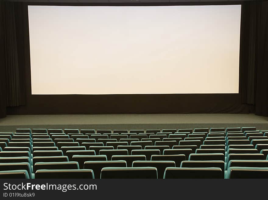 Empty cinema auditorium with line of green chairs and silver screen. Ready for adding your own picture. Empty cinema auditorium with line of green chairs and silver screen. Ready for adding your own picture.