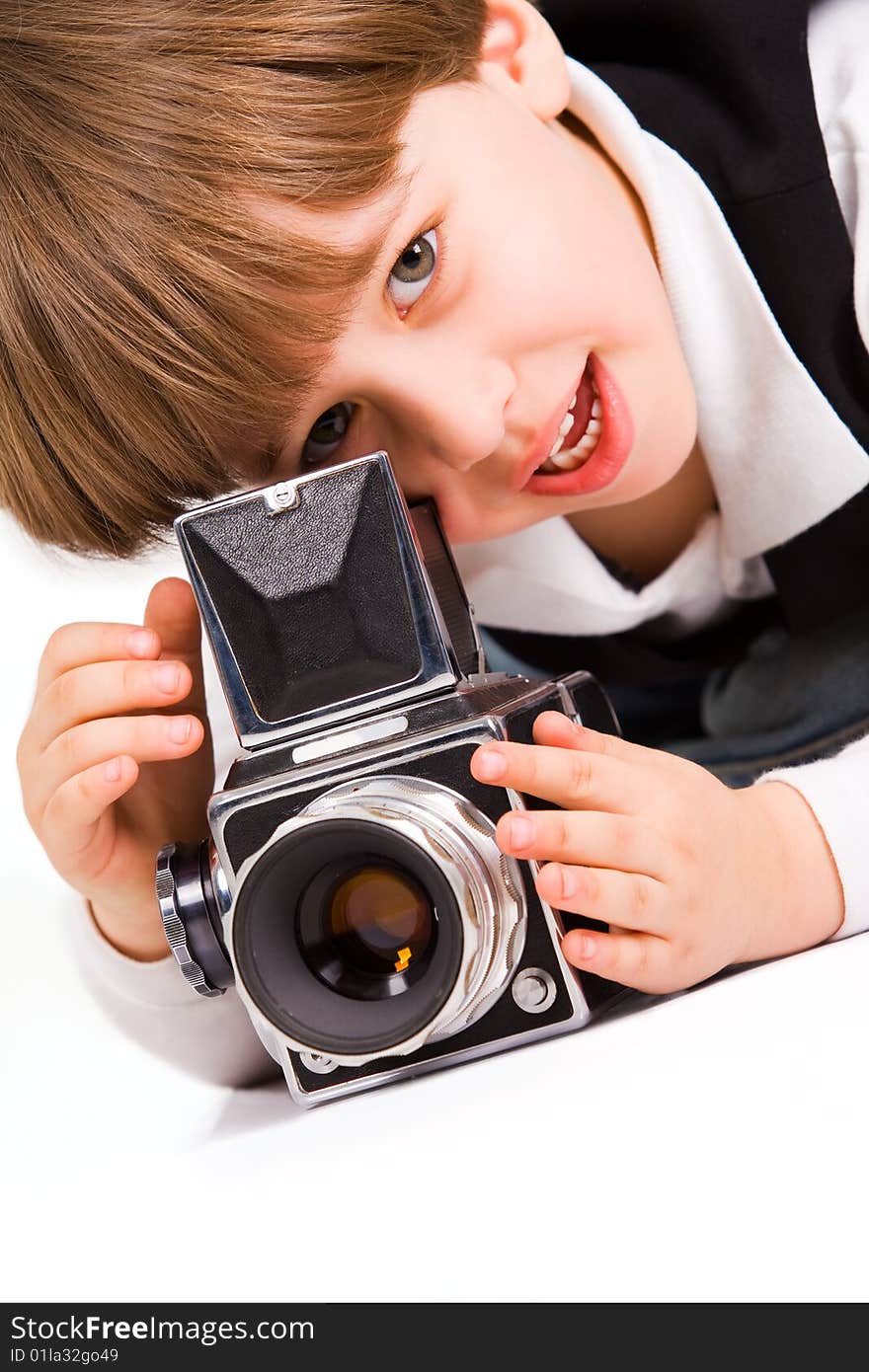 Attractive little boy with photo camera over white. Attractive little boy with photo camera over white