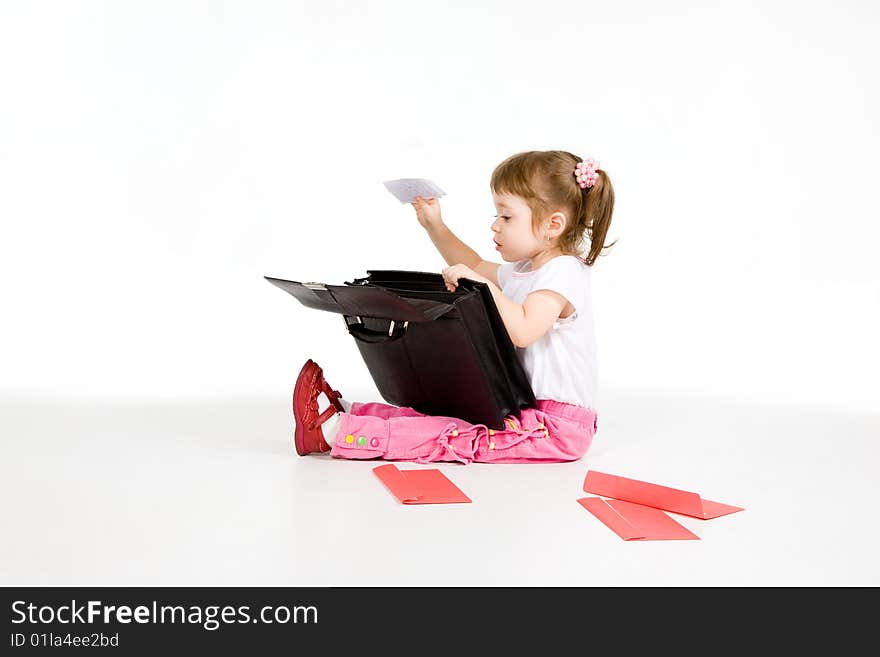 Little girl digging into briefcase