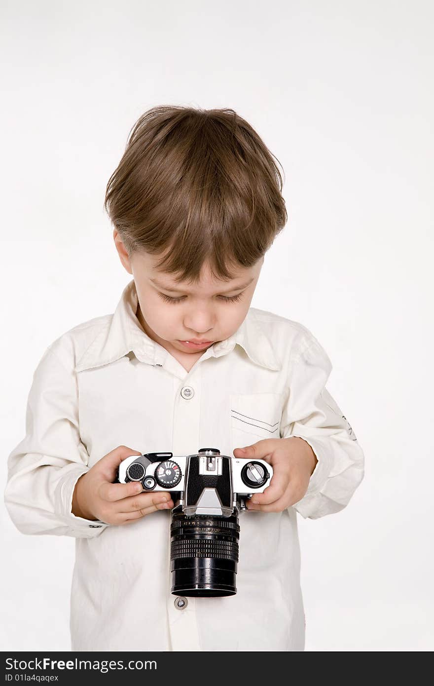 Attractive little boy with photo camera over white. Attractive little boy with photo camera over white