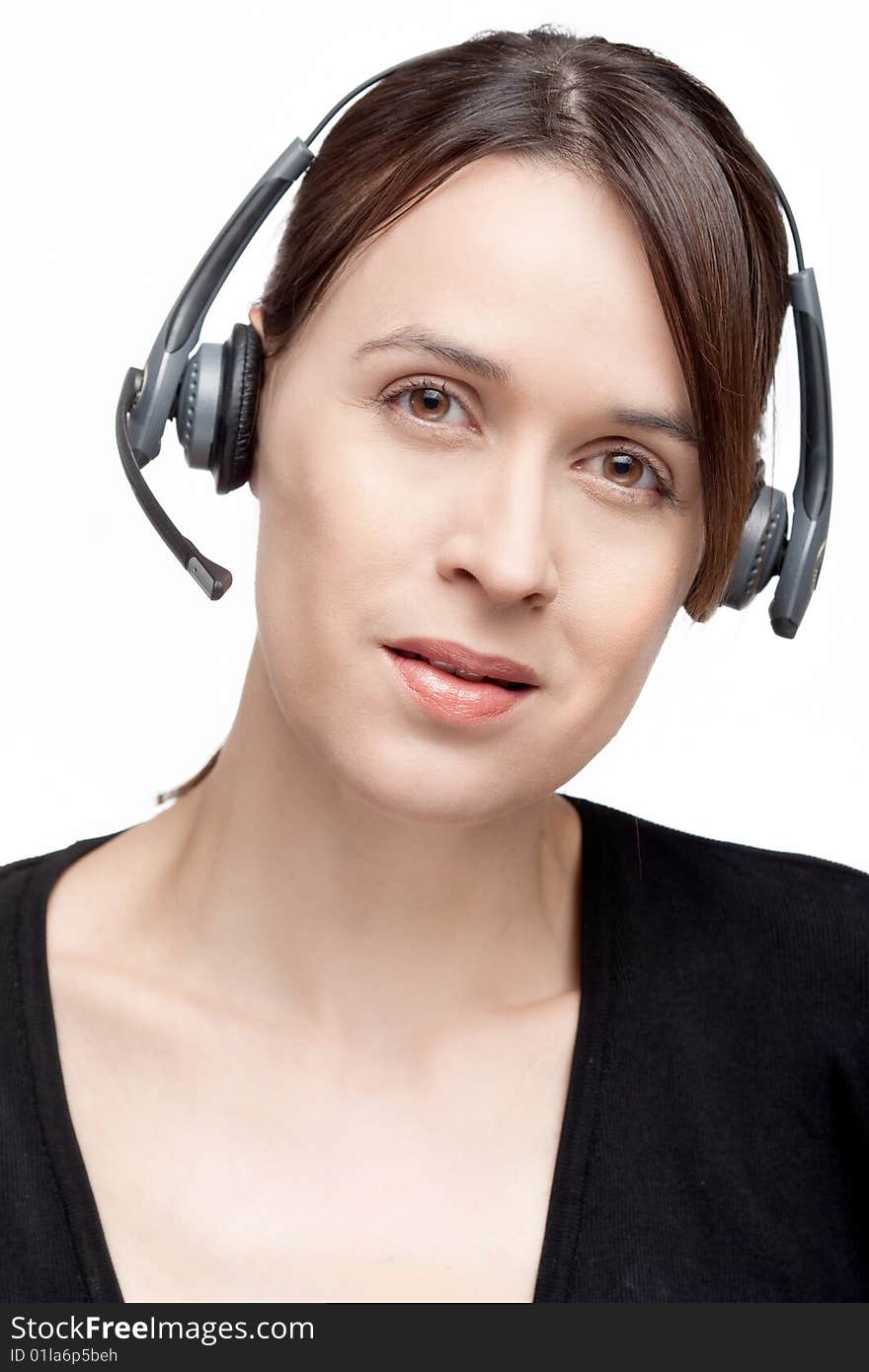 A woman with a headset communications gear on white. A woman with a headset communications gear on white.