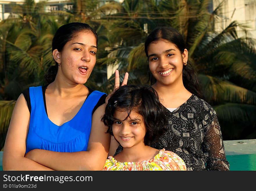 A group of three sisters teasing the onlooker. A group of three sisters teasing the onlooker.