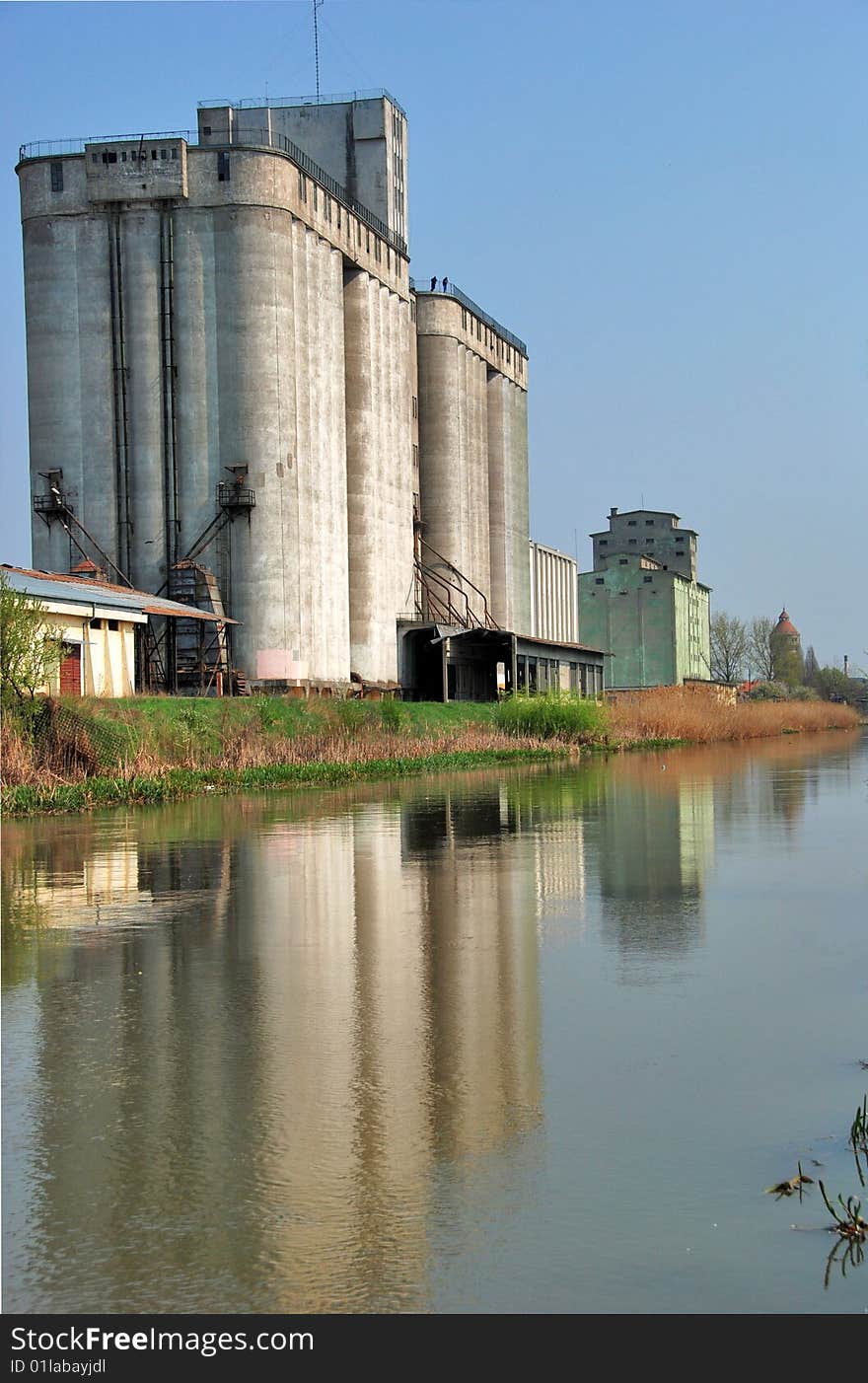 A view with a concrete silo reflected in. A view with a concrete silo reflected in