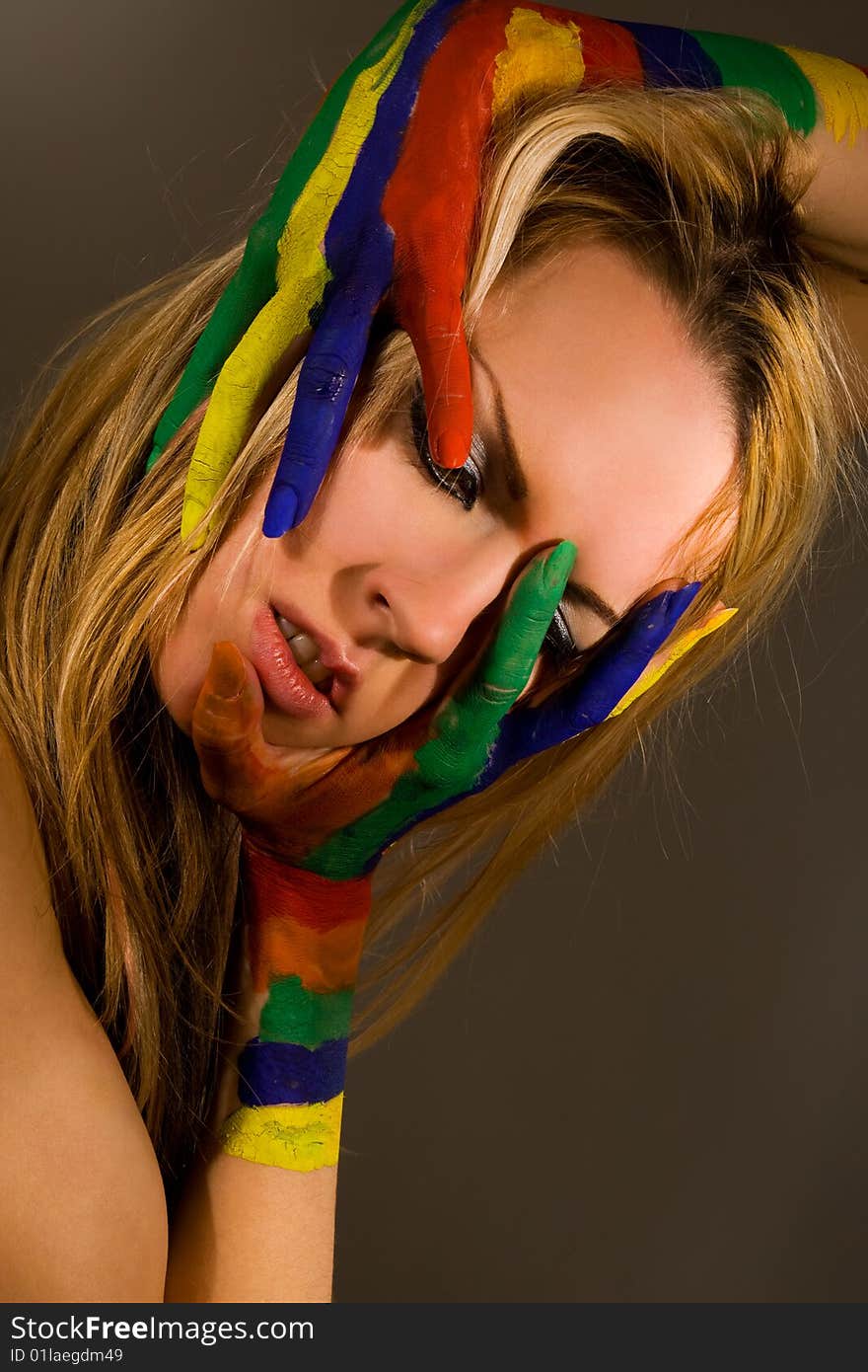 Pretty female model with hands painted rainbow style. Pretty female model with hands painted rainbow style