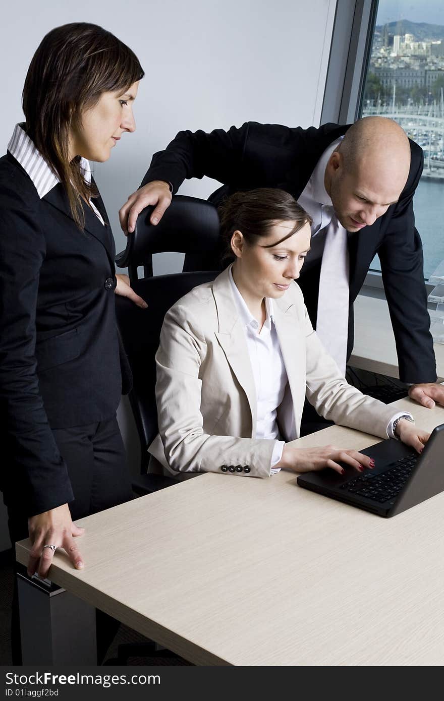 Young businessteam of three persons in office