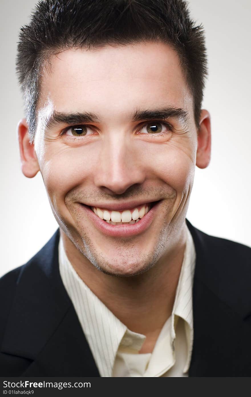 Cheerful young businessman close up portrait