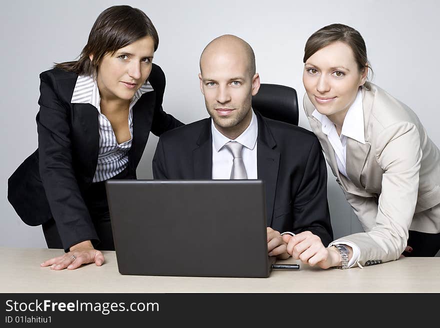 Young businessteam of three persons in office