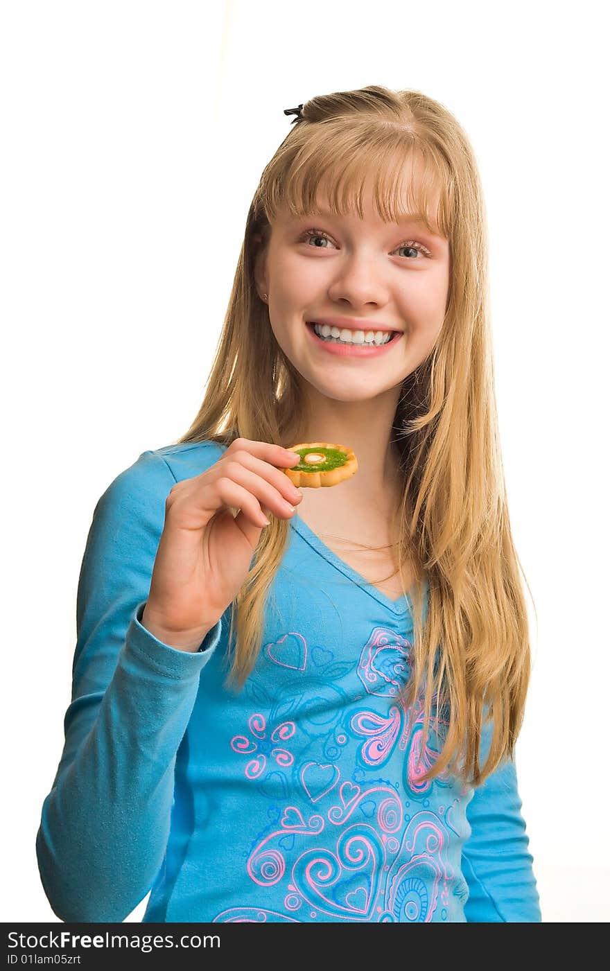 Young blonde girl with biscuit in hand. Young blonde girl with biscuit in hand