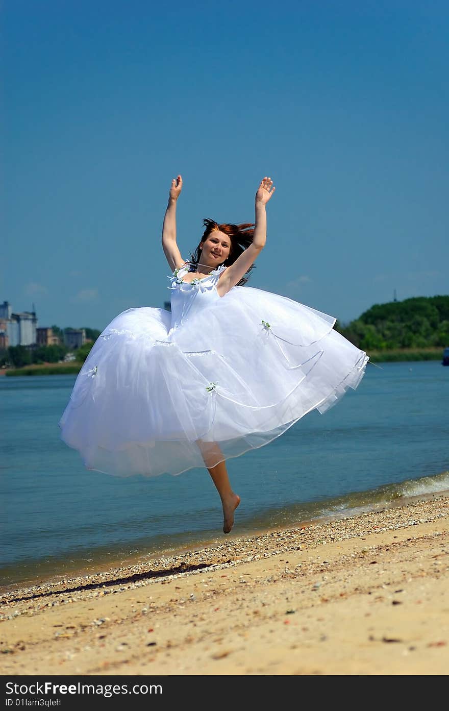 Bride jumping on a sandy beach. Bride jumping on a sandy beach