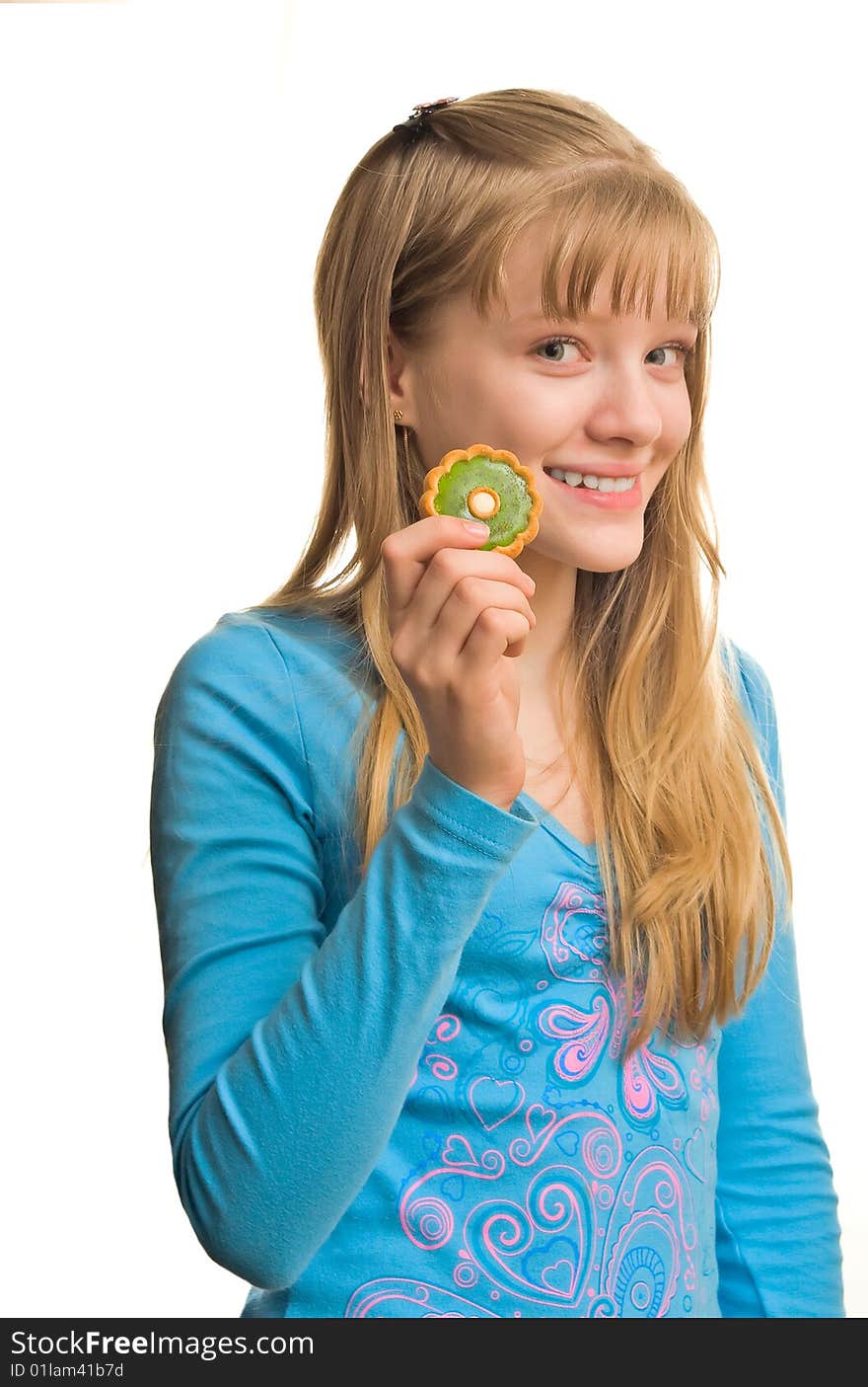 Young blonde girl with biscuit near her mouth. Young blonde girl with biscuit near her mouth