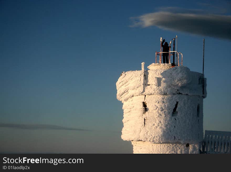 People standing on tower of mount washington observatory covered by rime ice. People standing on tower of mount washington observatory covered by rime ice