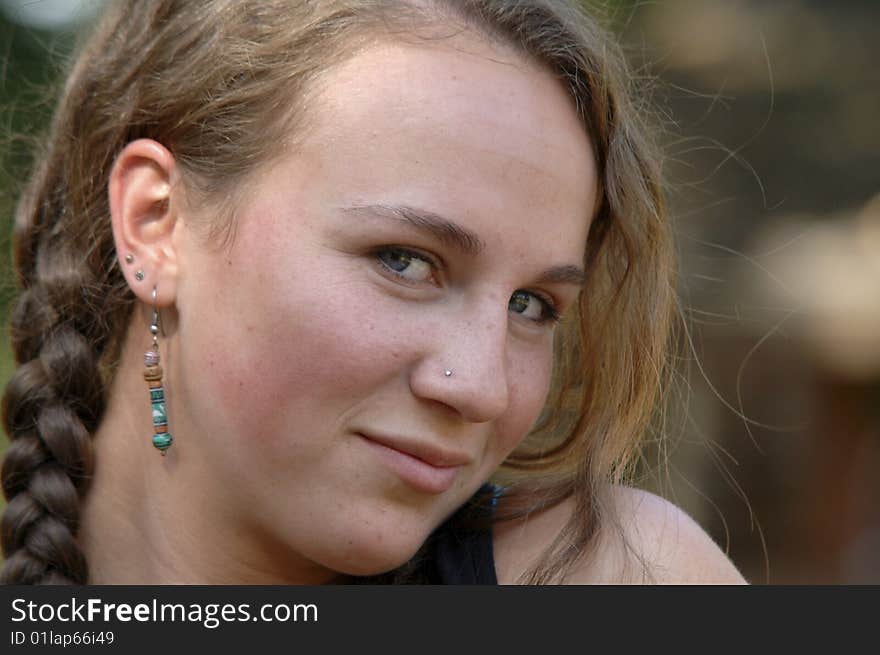 Outdoor portrait of a pretty teenage girl with braids. Outdoor portrait of a pretty teenage girl with braids.