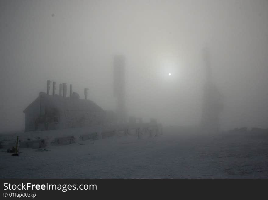 Rime ice covered stage office and antenna of mount washington in fog with special effects. Rime ice covered stage office and antenna of mount washington in fog with special effects