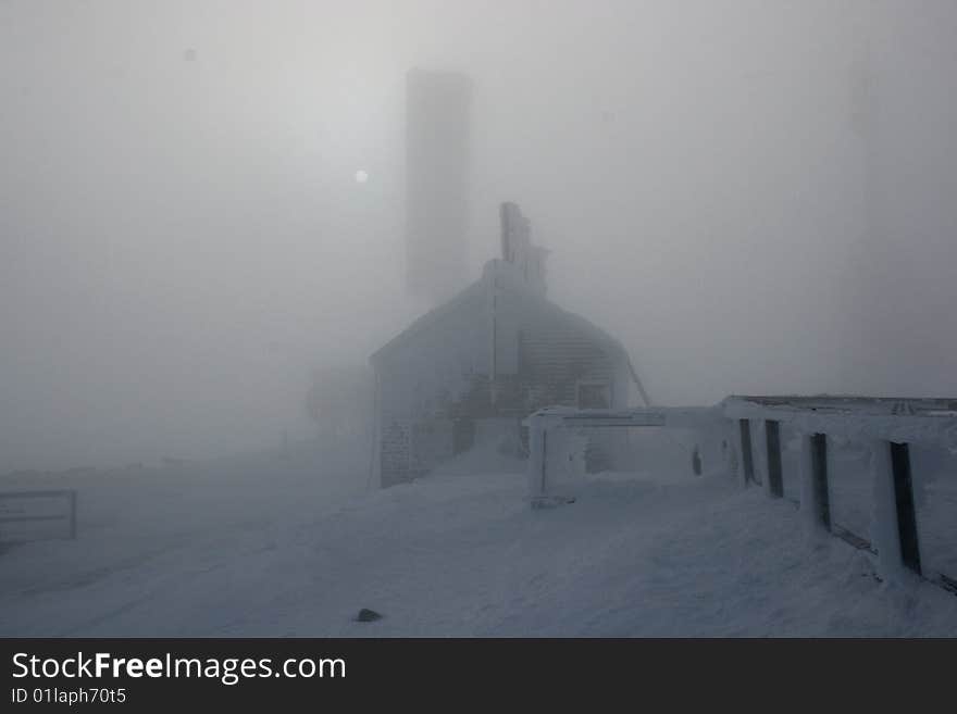 Rime ice covered stage office and antenna of mount washington in fog with special effects. Rime ice covered stage office and antenna of mount washington in fog with special effects