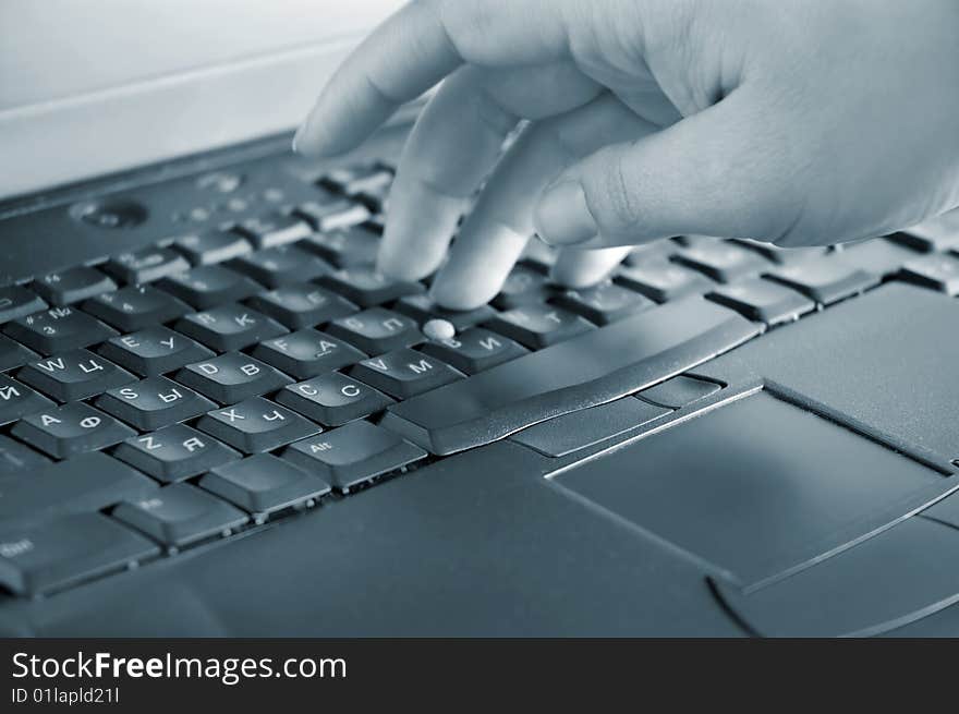 Close up of a hand typing on laptop keyboard. Close up of a hand typing on laptop keyboard