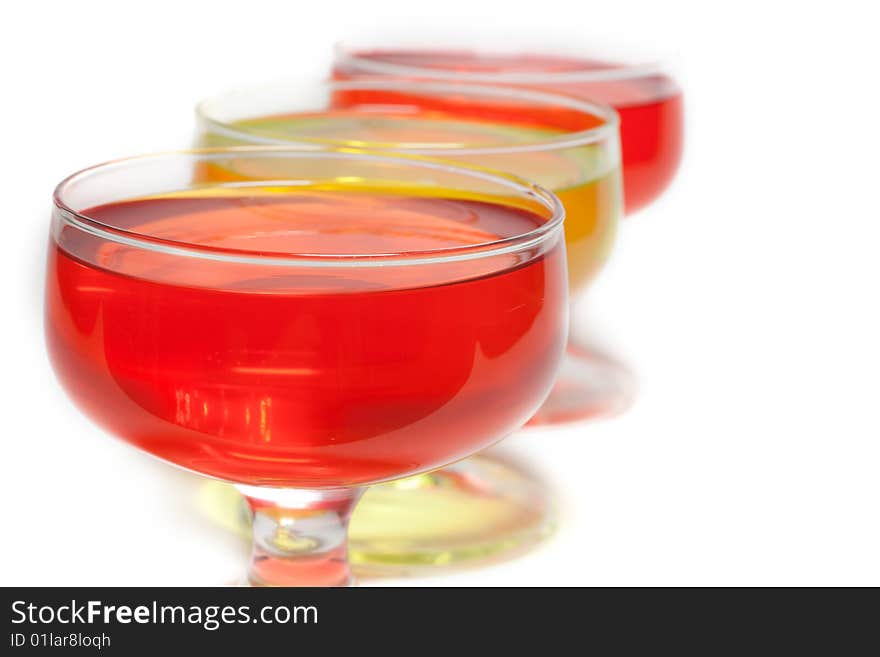 Yellow, red jelly in transparent glass stand on white background inline. Yellow, red jelly in transparent glass stand on white background inline