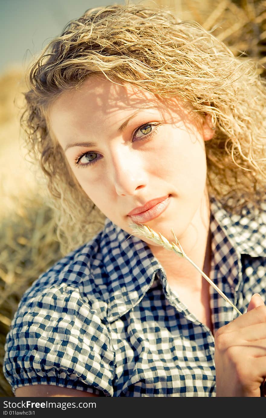 Beautiful country girl lying on the haystack. Beautiful country girl lying on the haystack