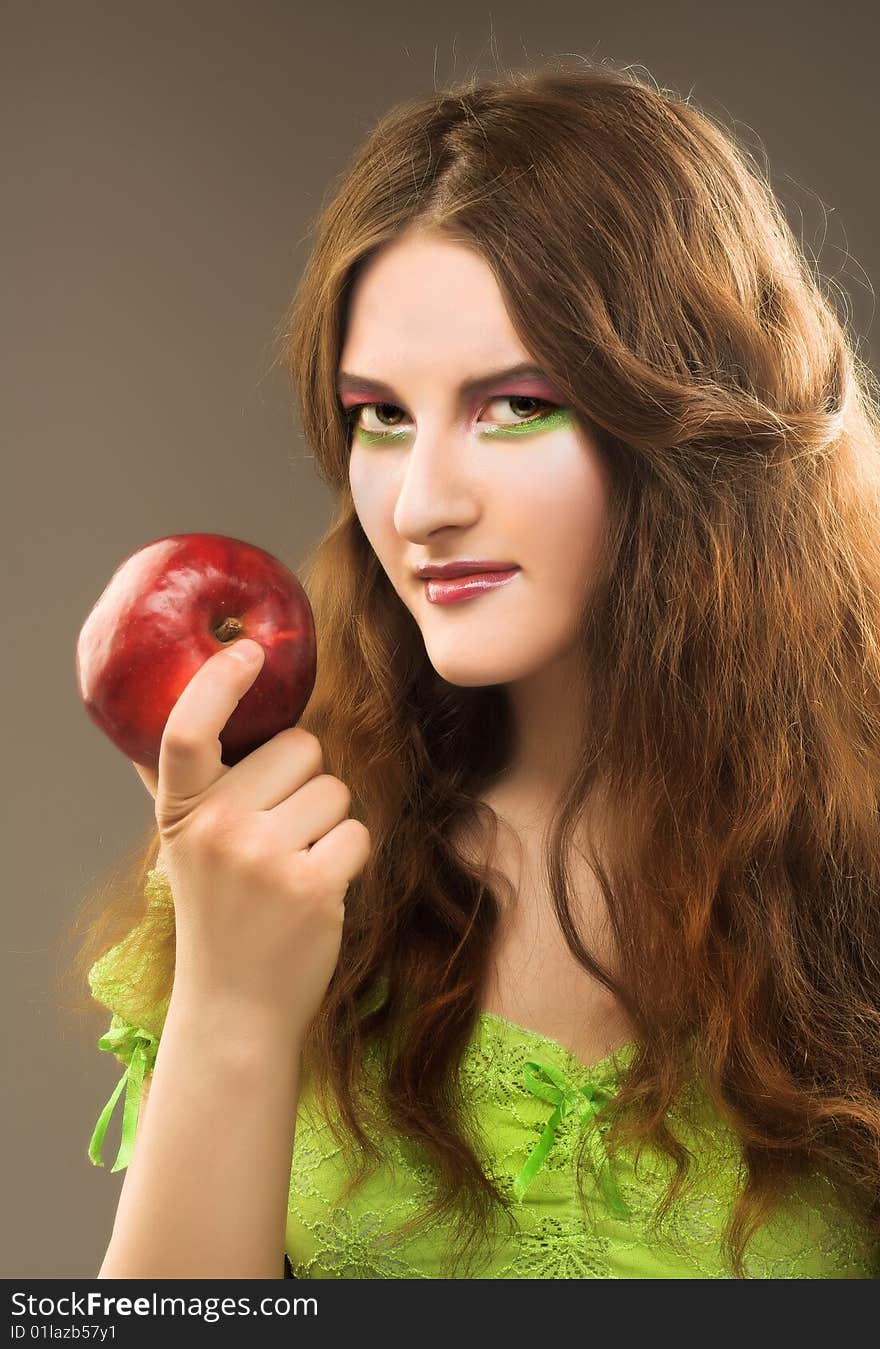 Portrait of young girl witn fresh red apple in her hand. Portrait of young girl witn fresh red apple in her hand