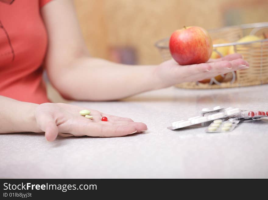 A photo of young girl with green and red vitamin. A photo of young girl with green and red vitamin