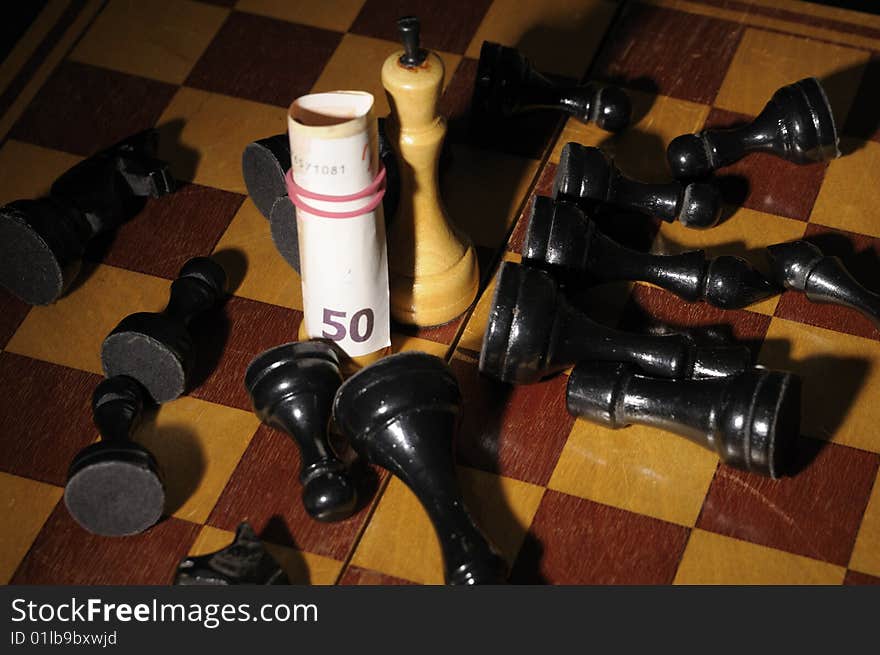 Chess on chessboard with banknote participating in a game. Chess on chessboard with banknote participating in a game