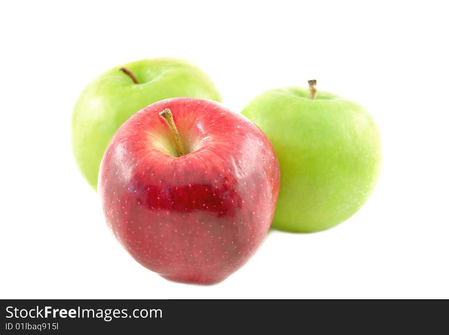 One red and two green apples on a white background. One red and two green apples on a white background.